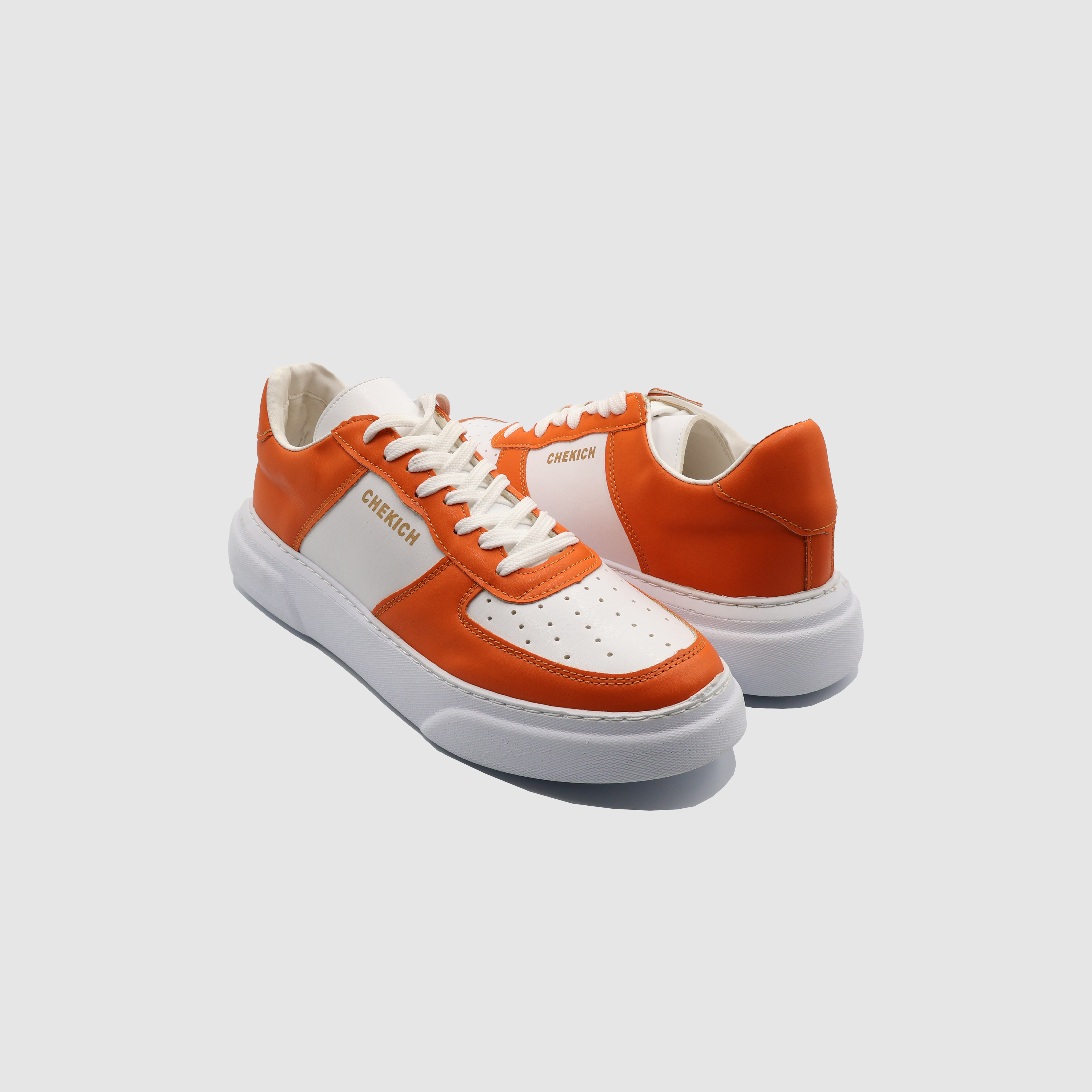 Orange Shopify Flatline sneakers with sleek design and white sole, displayed on a white background.