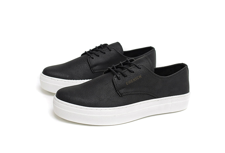 Black Pitti sneakers by Shopify with sleek design and white sole, shown from a side angle on a white background.