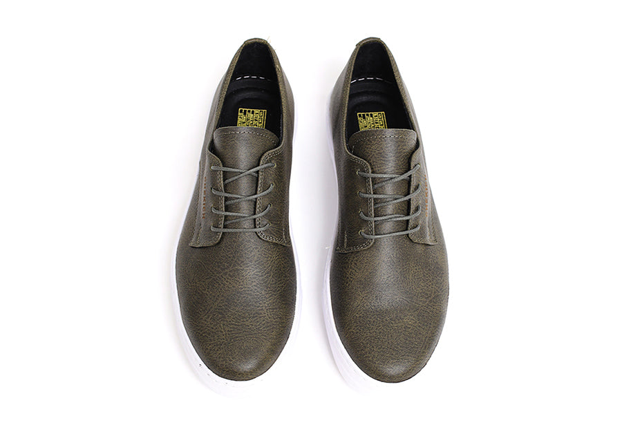 Shopify Pitti Green sneakers with white soles and green upper, casual athletic style, close-up view of the stylish footwear.