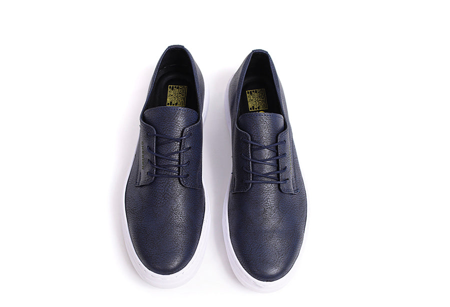Navy Pitti Sneakers by Shopify featuring a sleek design with white soles and navy fabric, perfect for casual wear.
