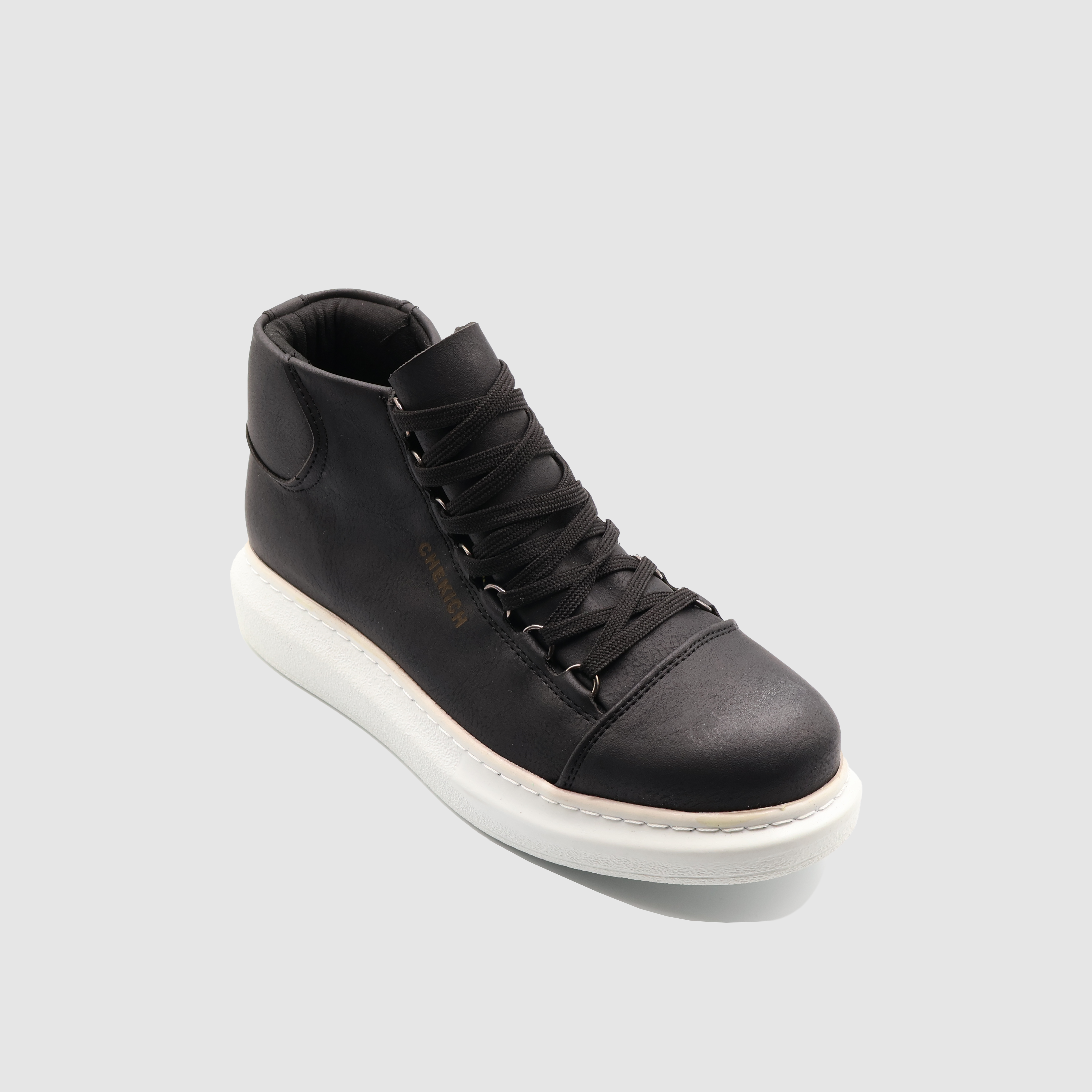 Black Roma boots by Shopify featuring a sleek design and white accents, displayed on a white background.