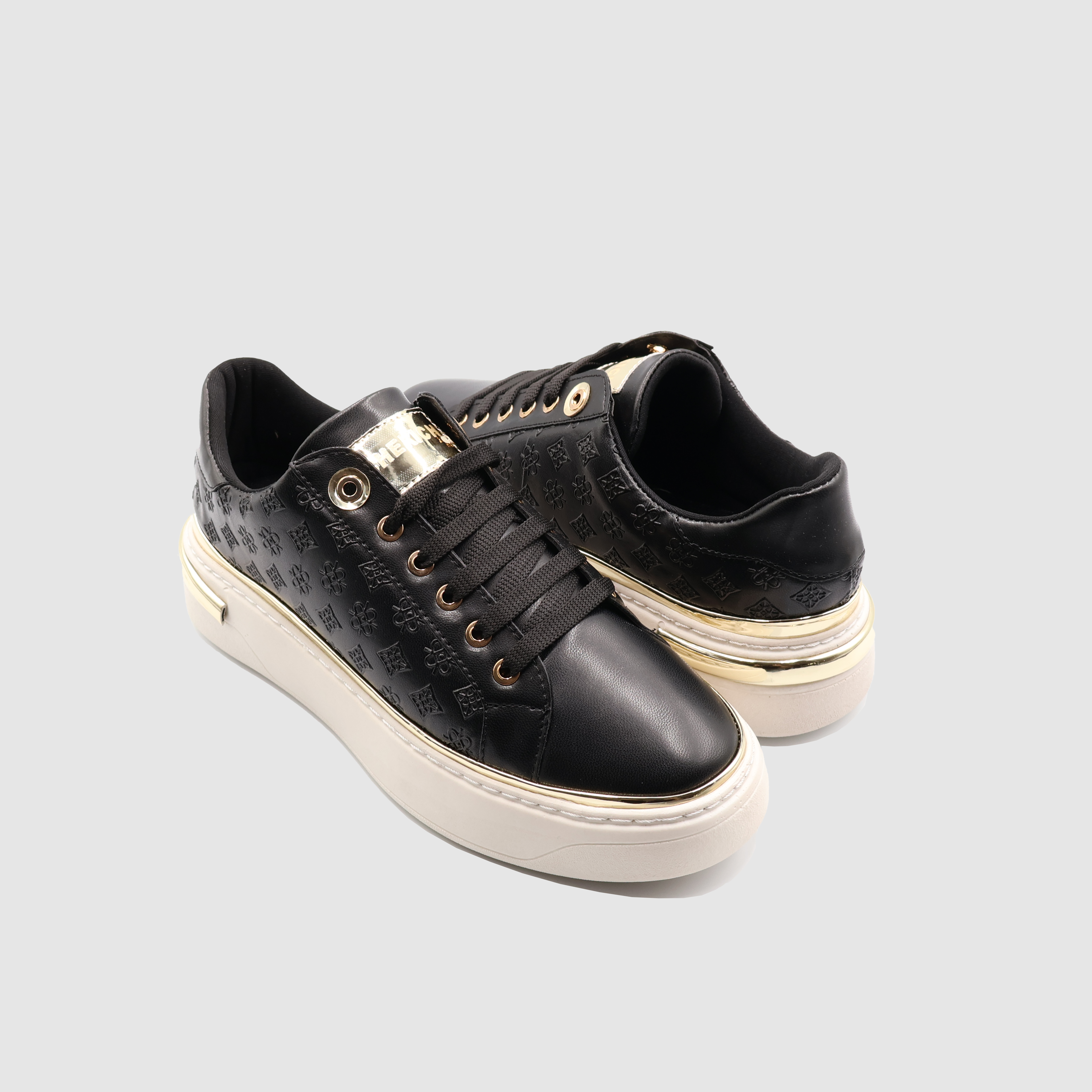 Black Shopify Soon Sneakers with sleek design and white sole, displayed on a neutral background.