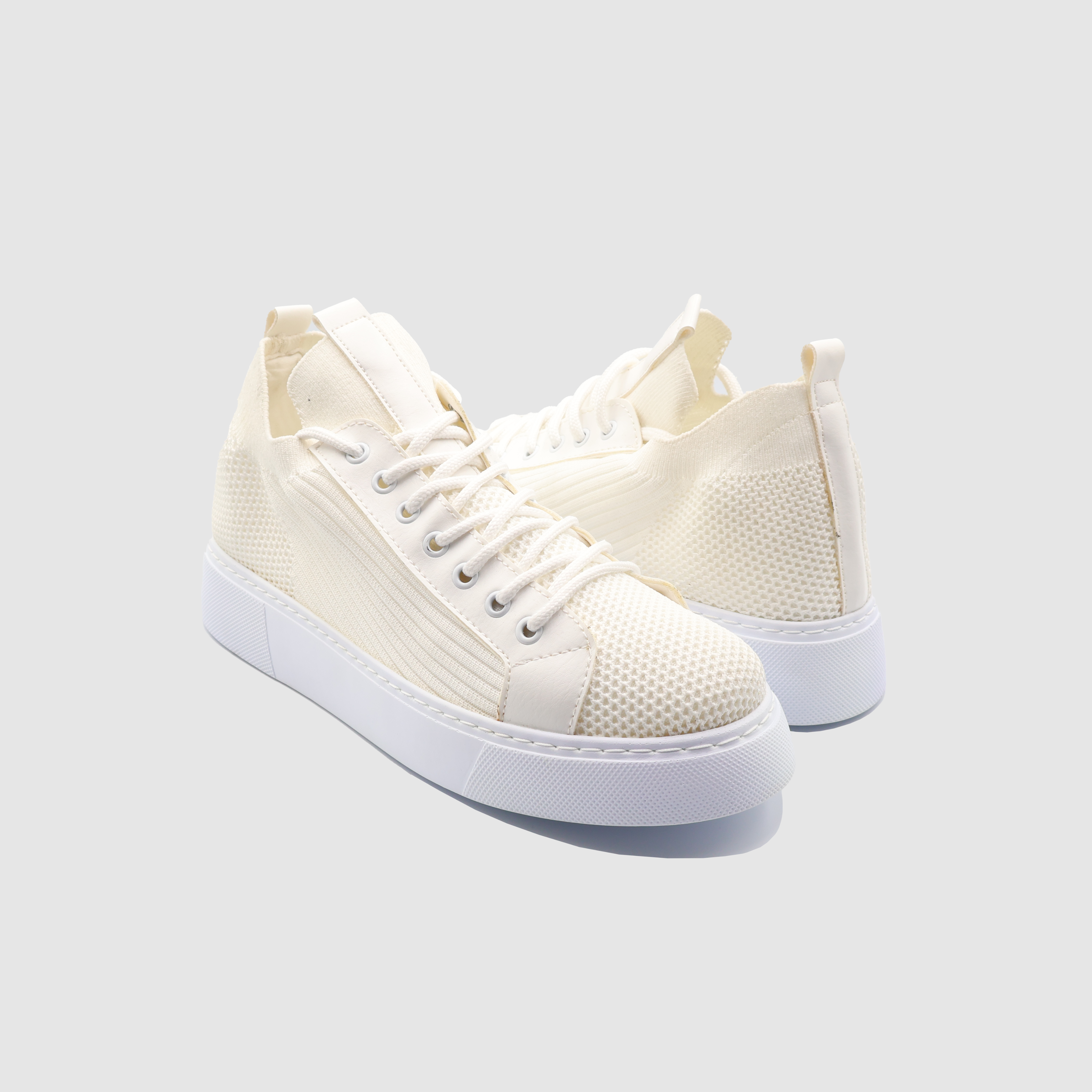 White SAGA sneakers by Shopify featuring a sleek design and comfortable fit, ideal for casual wear and everyday style.