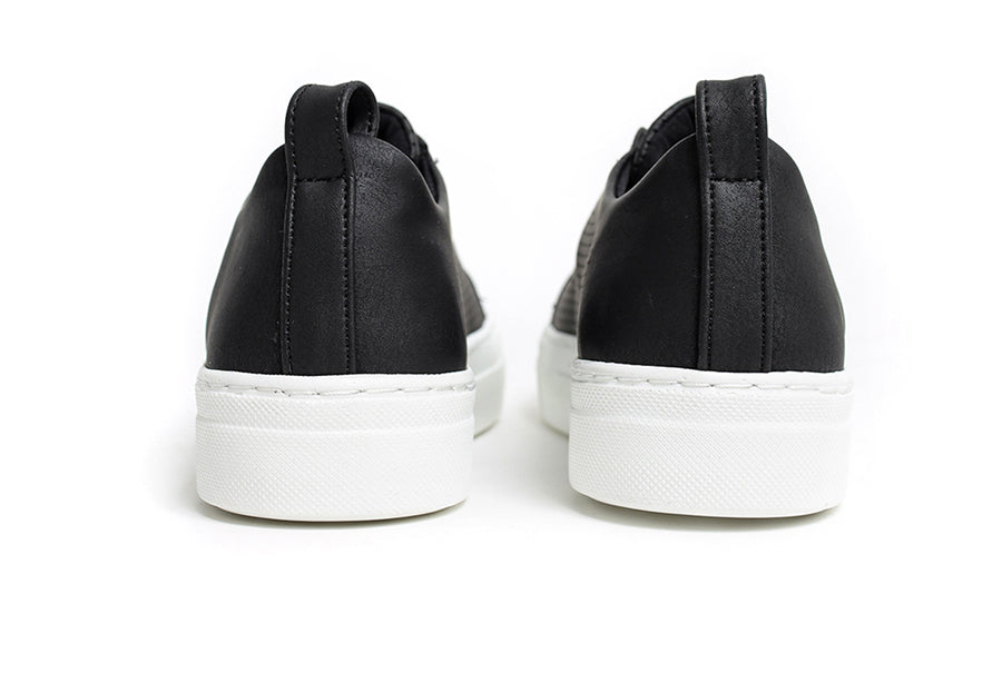 Black ZEN Sneakers by Shopify, featuring a sleek design and comfortable fit, displayed from an angled side view.