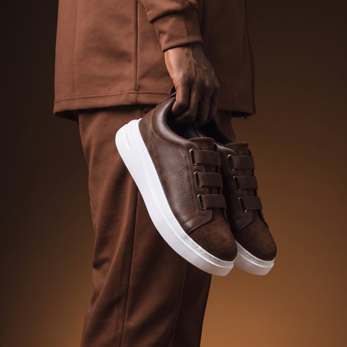 Chekich South Africa NONE V2 Brown sneaker with leather upper and stylish design, shown from a side angle.