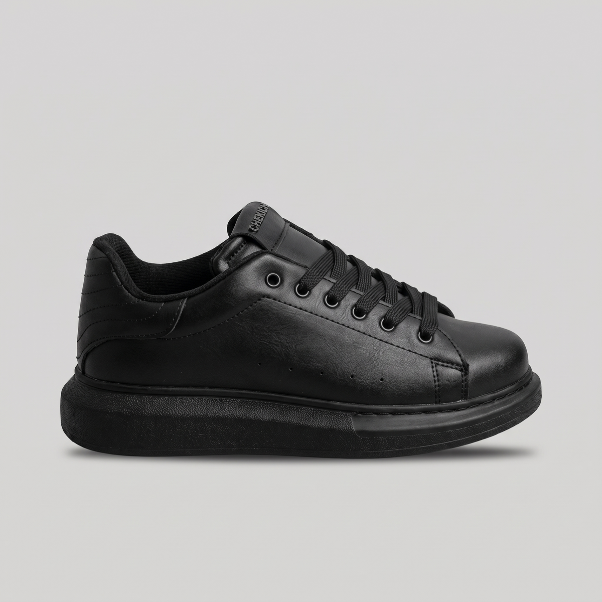 Chekich ORIGIN All Black sneakers, side view of the black lace-up upper on a black platform sole