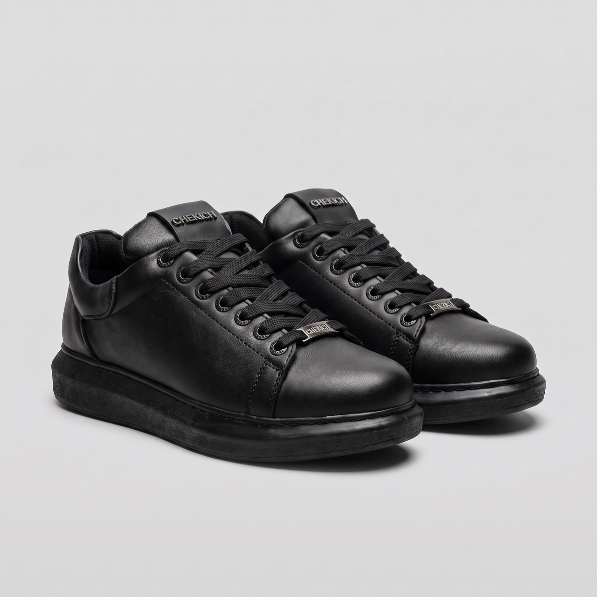 Shopify Fantasia Plain All Black sneakers with sleek design, rubber sole, and minimal branding on a white background.