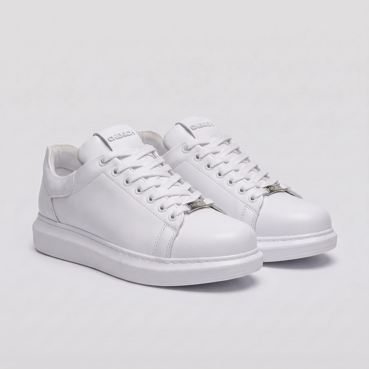 White FANTASIA Plain sneakers by Shopify featuring a minimalist design and clean white canvas upper with white laces.