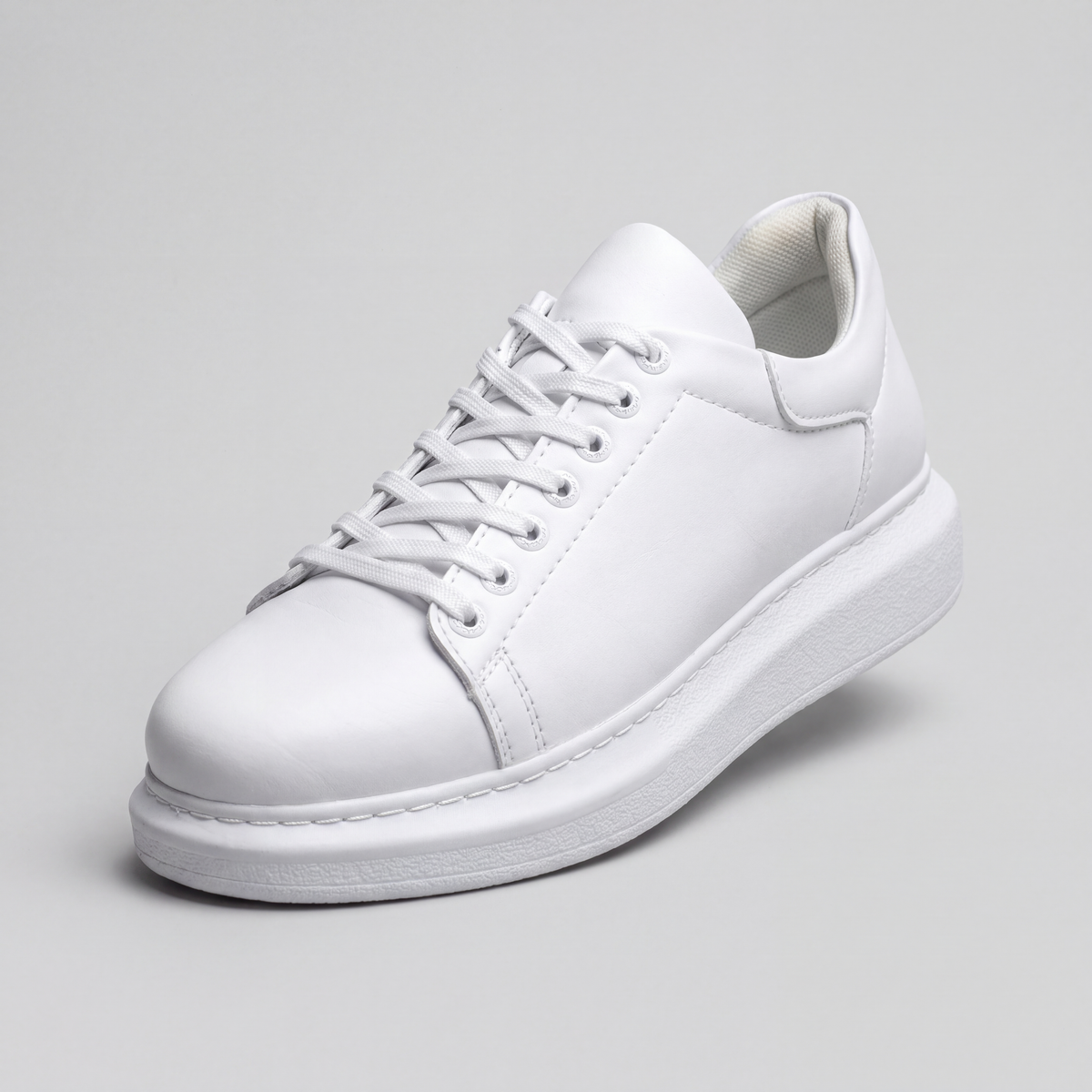 White sneakers from Shopify's Fantasia Plain collection, featuring a sleek design and comfortable fit.