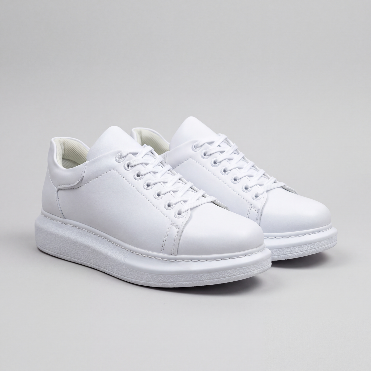 White Fantasia Plain sneakers by Shopify with smooth leather and classic design, showcasing laces and casual style.
