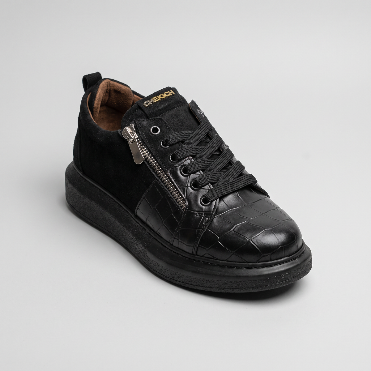 All black Chekich South Africa Phantom V2 sneaker shown from the side, highlighting sleek design and smooth black finish.