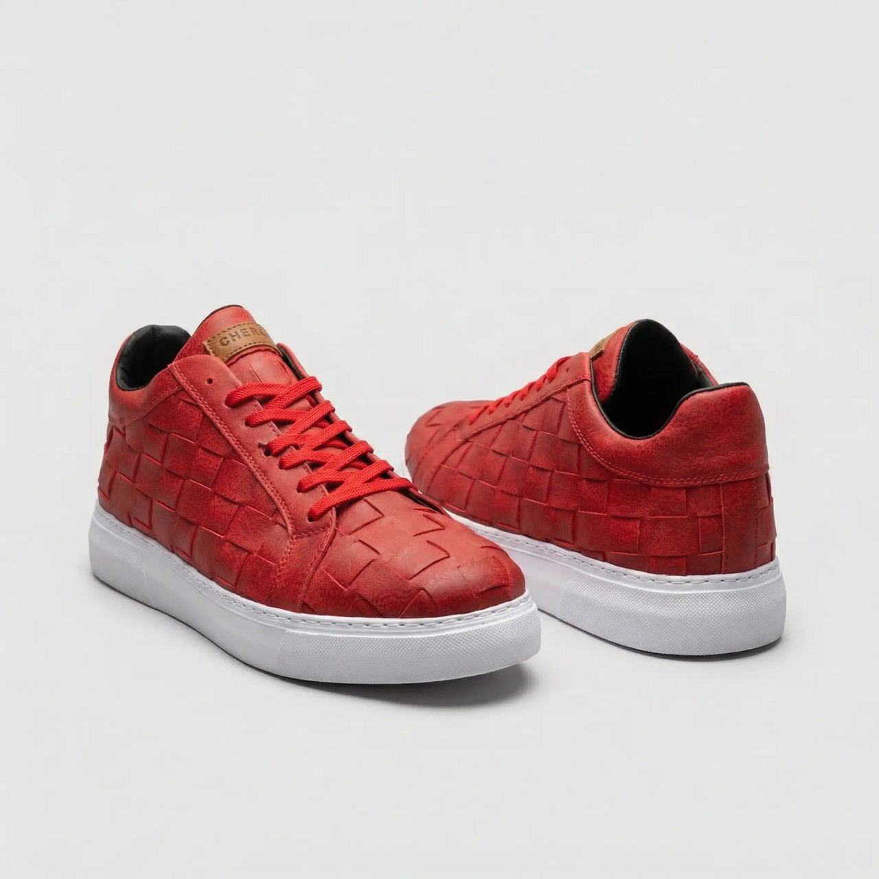 Red VIMINI sneakers by Shopify, stylish casual footwear with a sleek design and comfortable fit, shown in a close-up image.