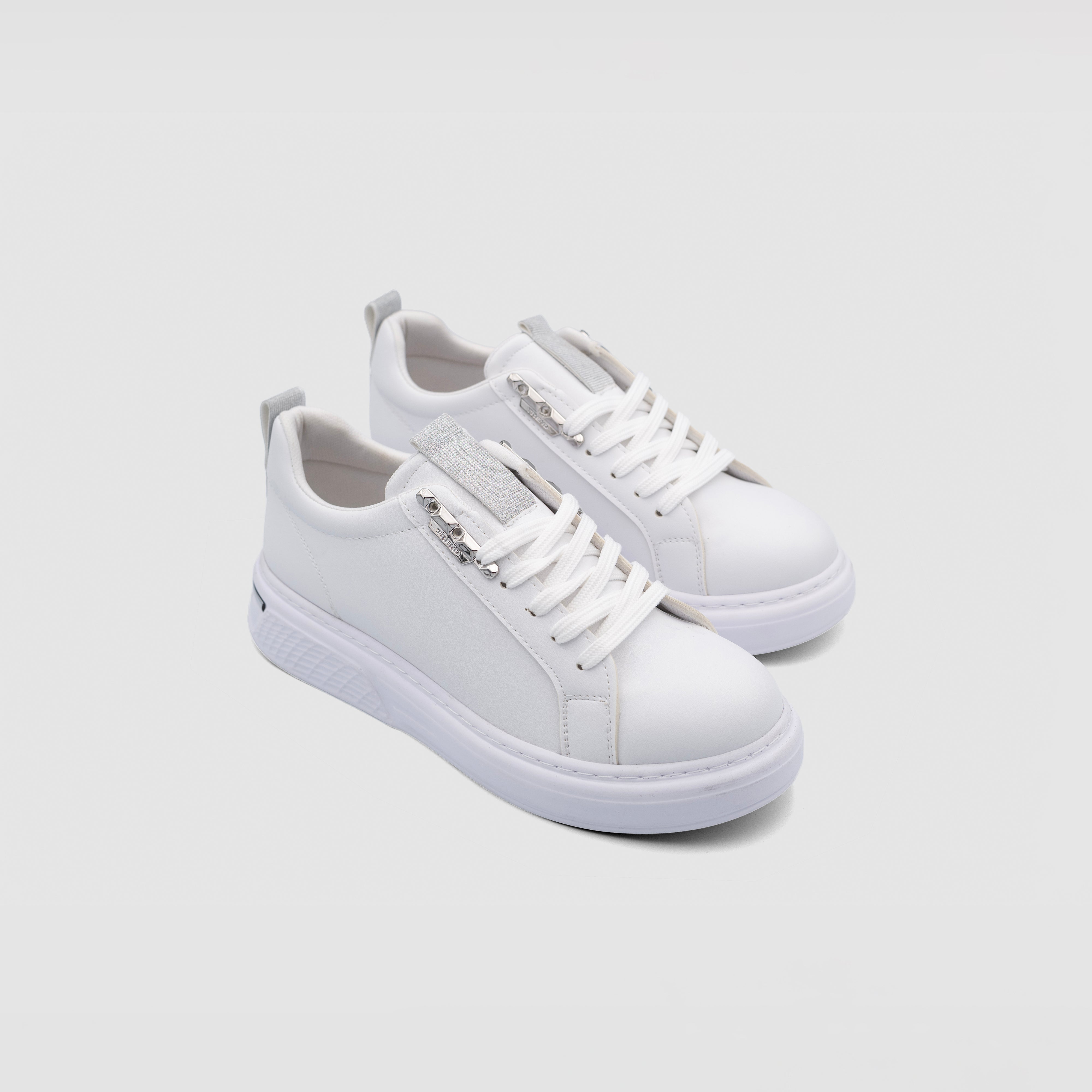 White Shopify Venom sneakers with sleek design and white laces, shown from a side view.
