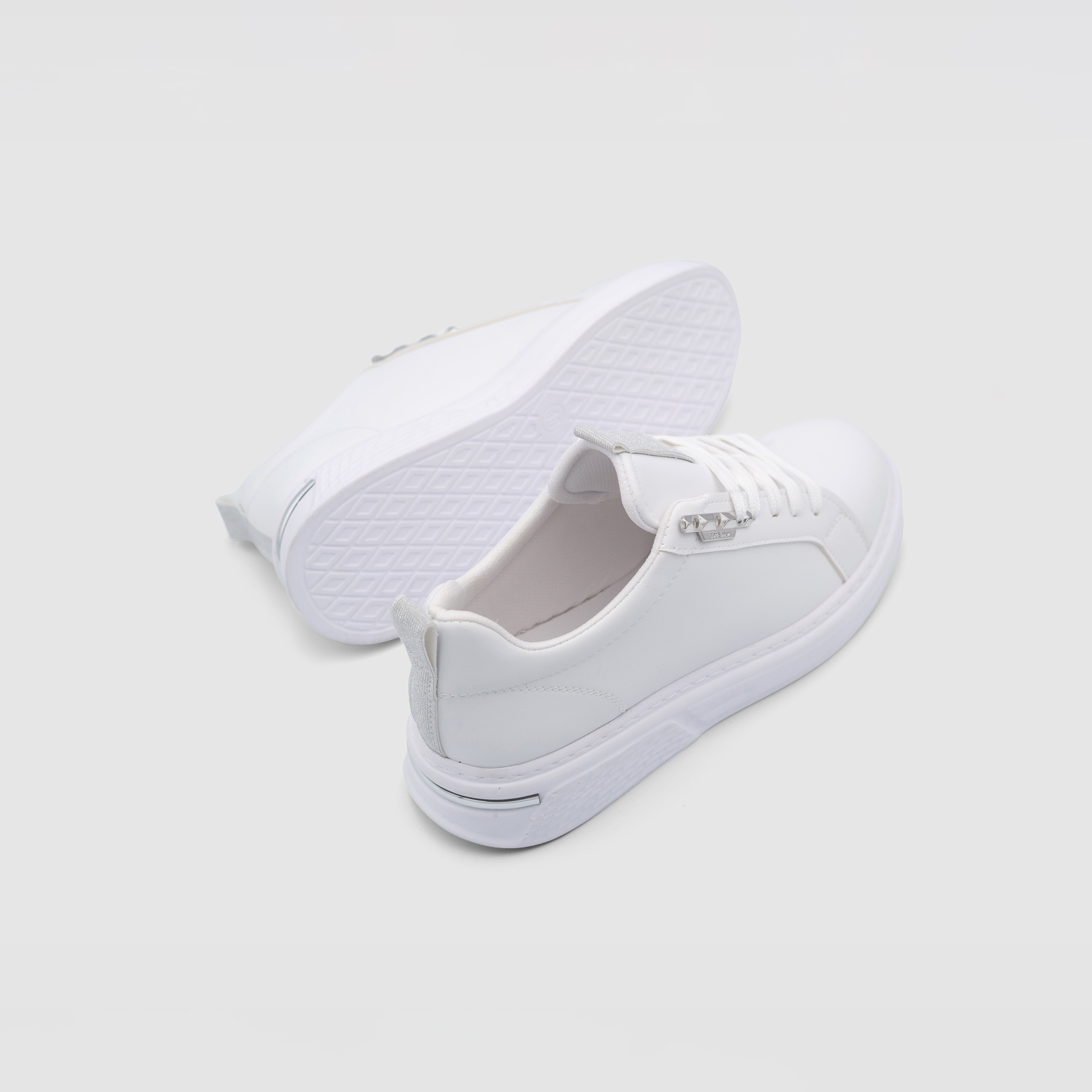 White Shopify VENOM sneakers with sleek design and breathable material, displayed on a neutral background.