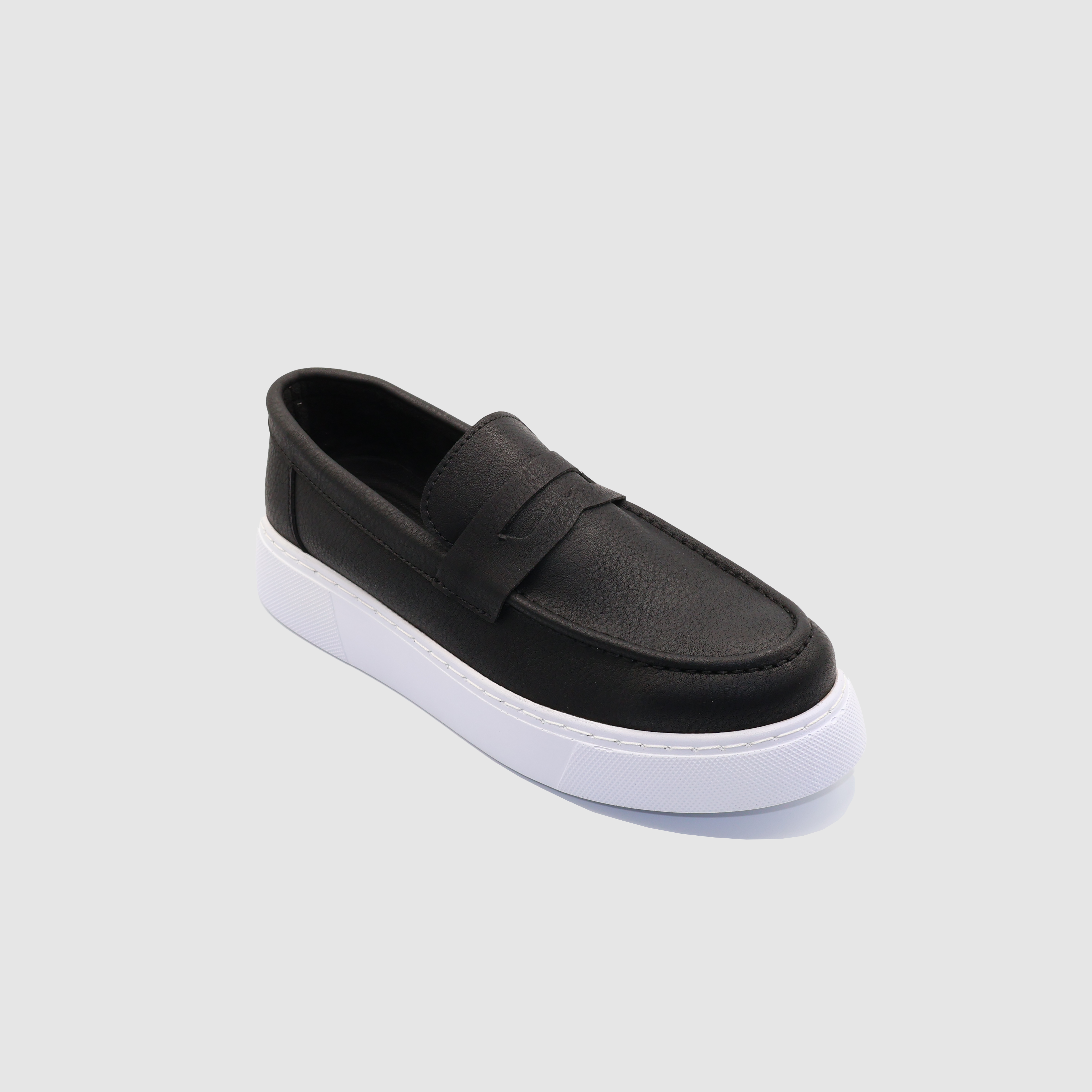 Black LOOM loafers by Shopify, showcasing sleek leather slip-on shoes with white accents and a modern design.