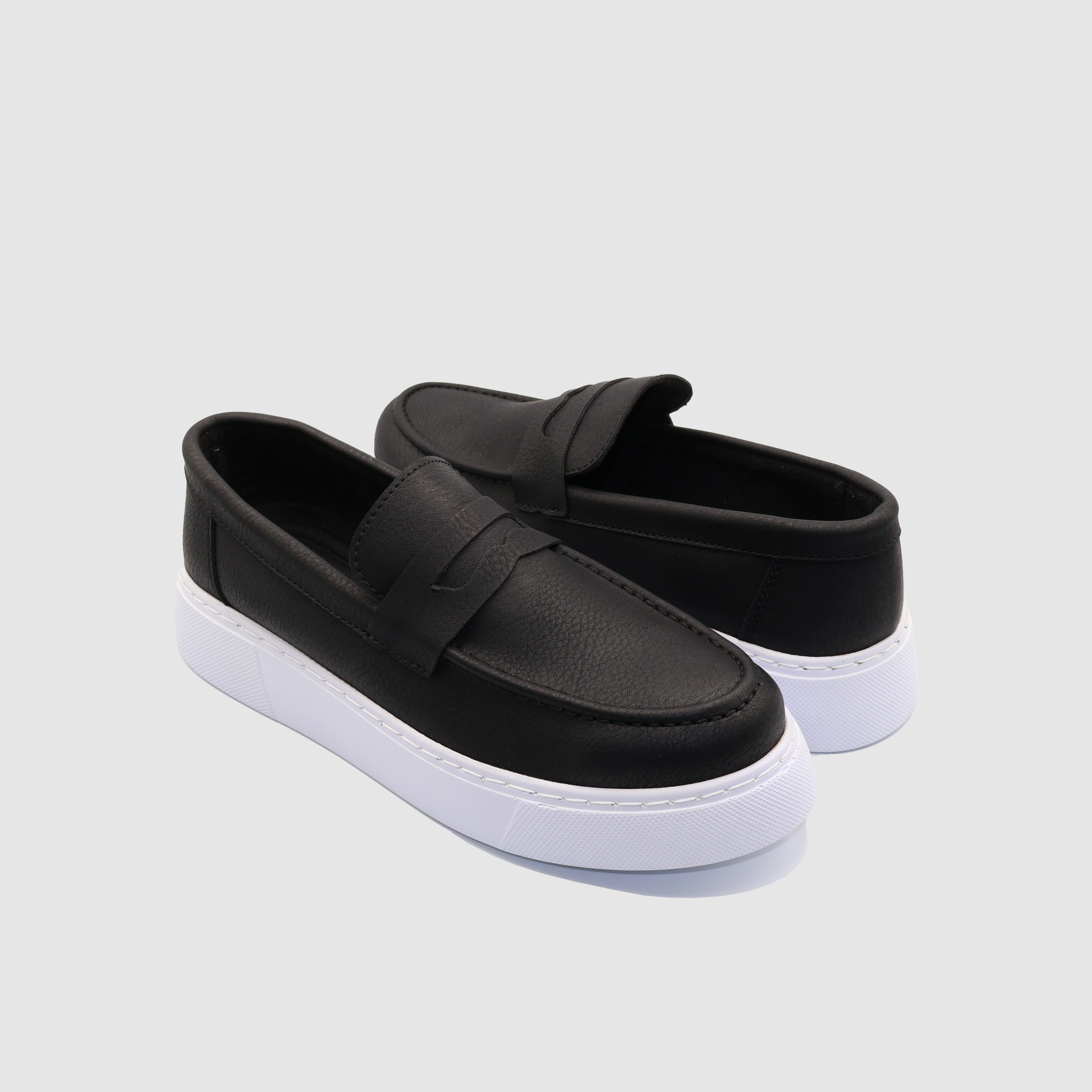 Black LOOM loafers from Shopify with sleek design and white accents, showcasing comfortable slip-on footwear for men.