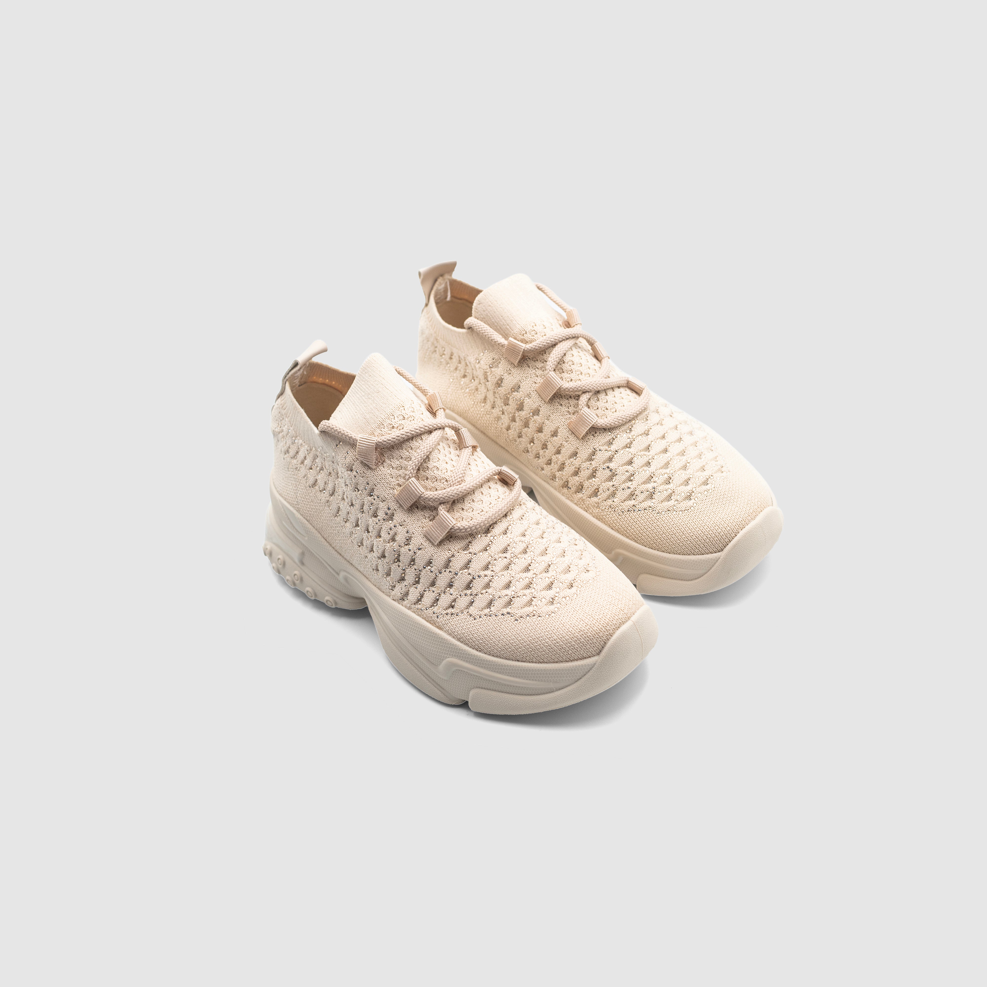 Beige Shopify PNut sneakers with white soles and laces, showcasing casual athletic footwear style.