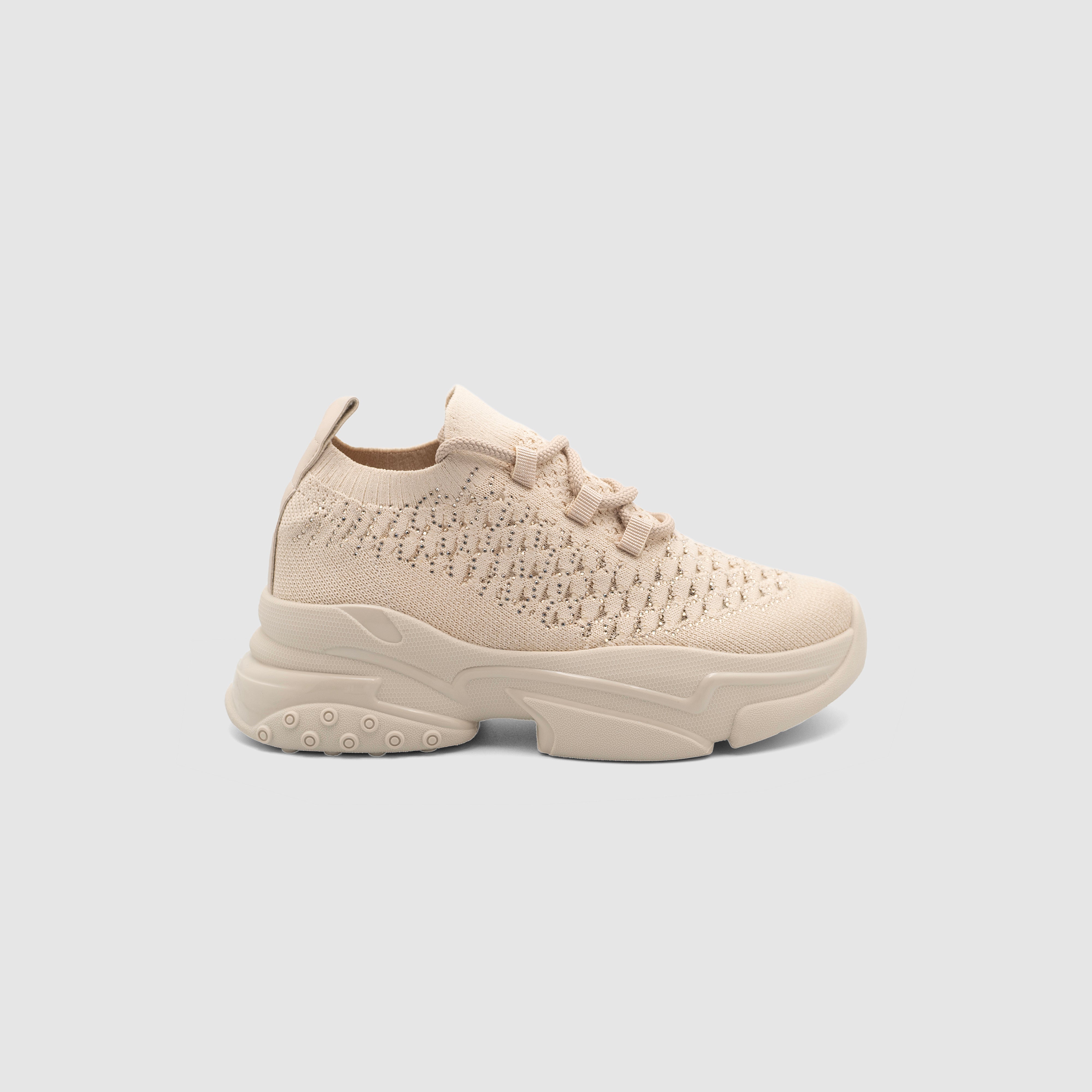 Shopify PNUT beige sneakers with white soles and sleek design, perfect for casual and sporty outfits.