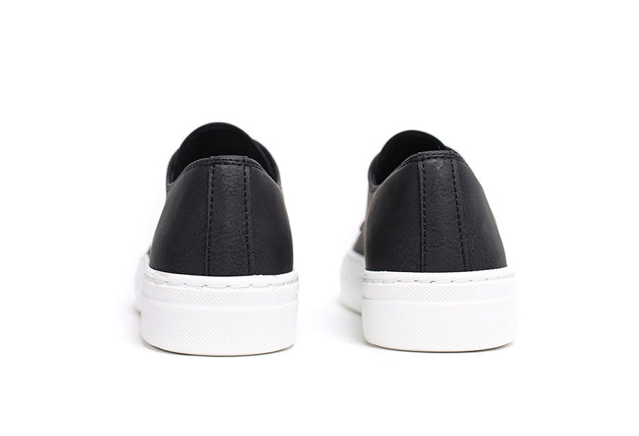 Black Pitti sneakers by Shopify displayed on a clean surface, showcasing their stylish design and comfortable fit.
