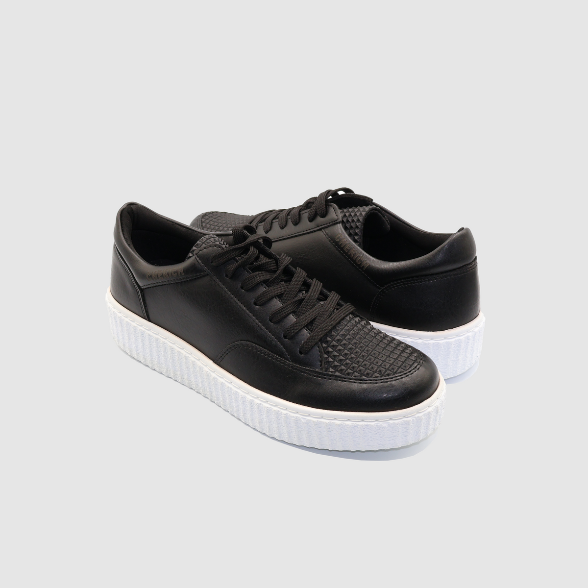 Black Pyramid sneakers by Shopify featuring a sleek design with white accents and a modern, stylish look.