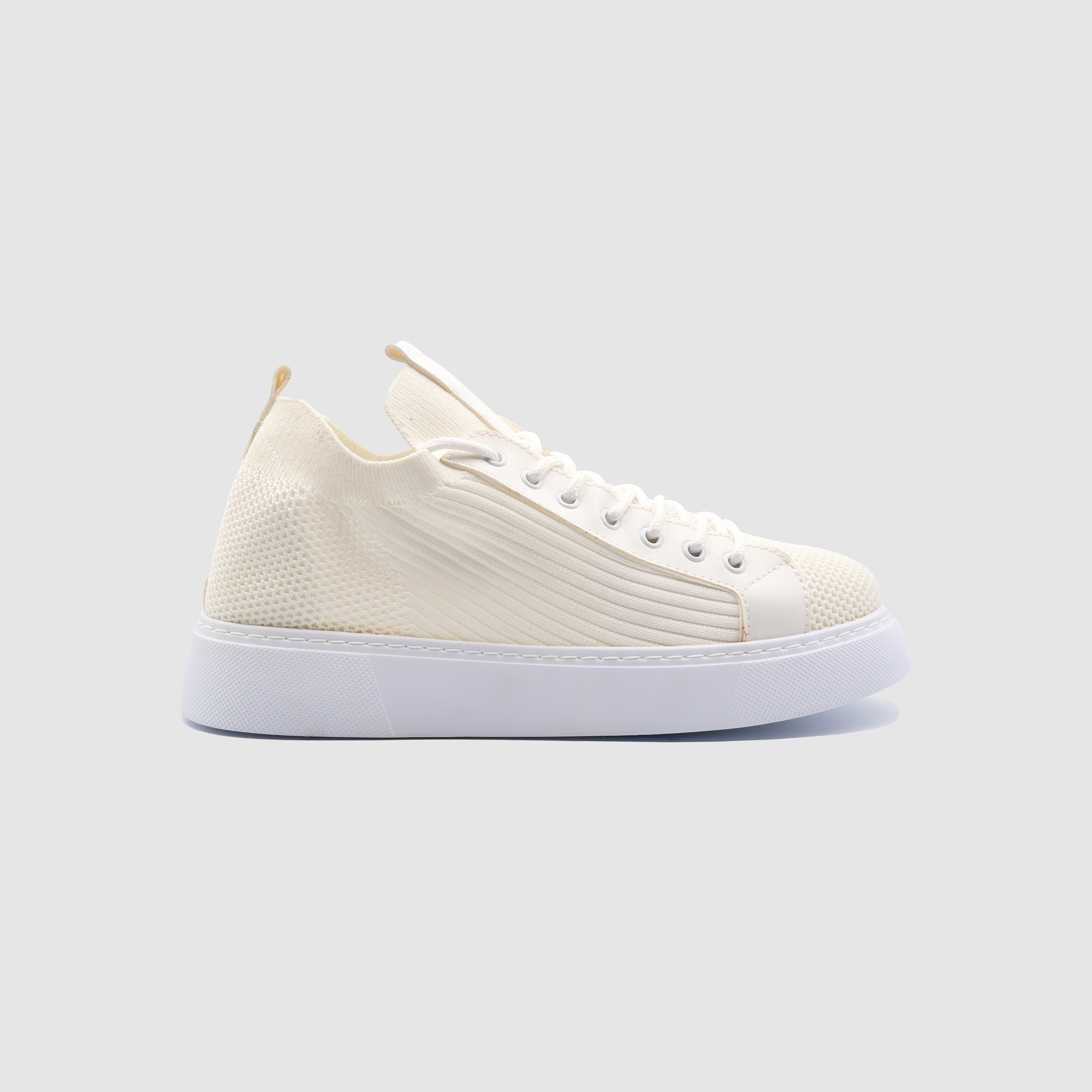 White SAGA sneakers by Shopify featuring a sleek design and comfortable fit, ideal for casual and sporty outfits.