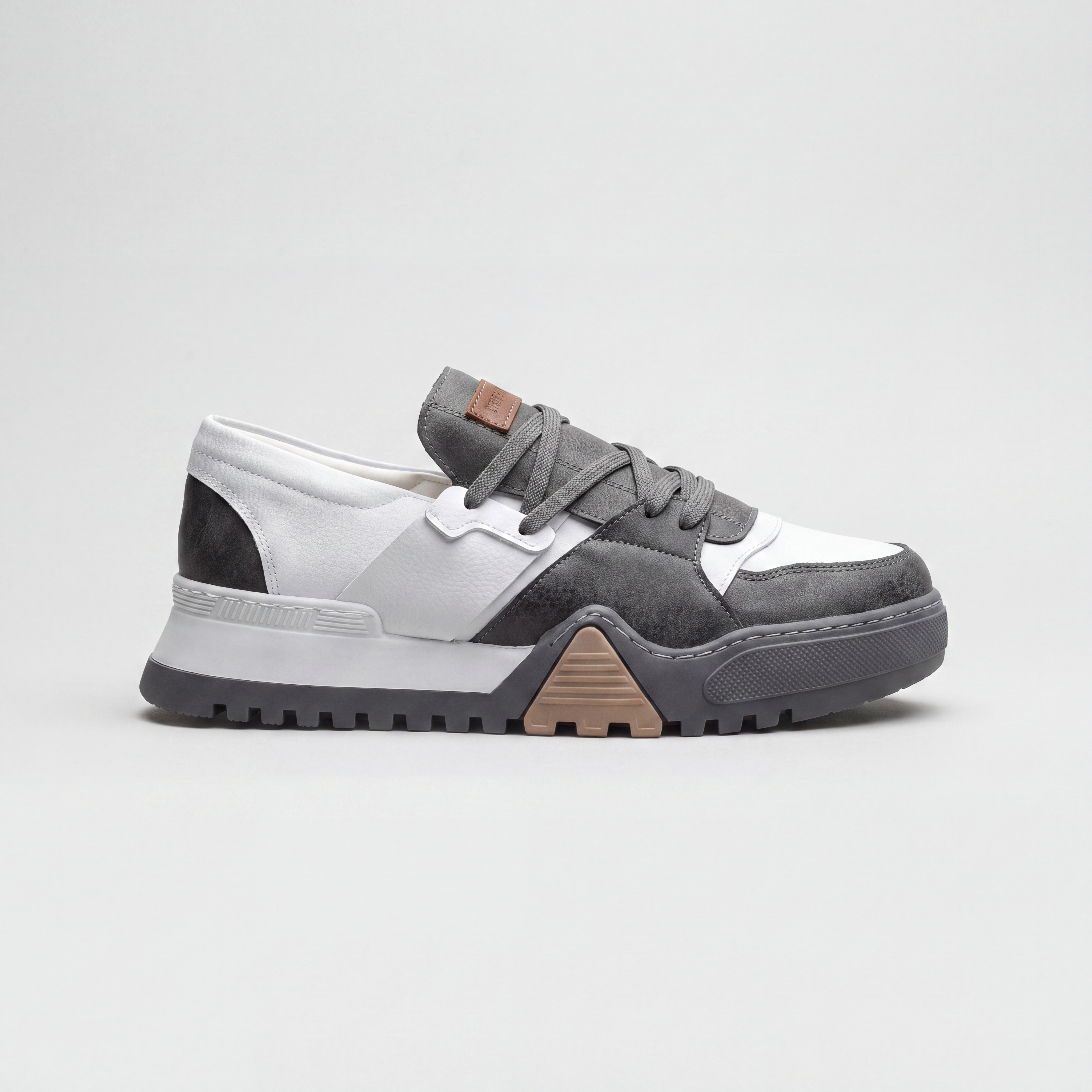 White Ghostline low cut sneakers by Shopify featuring a sleek design and comfortable fit, displayed on a plain background.