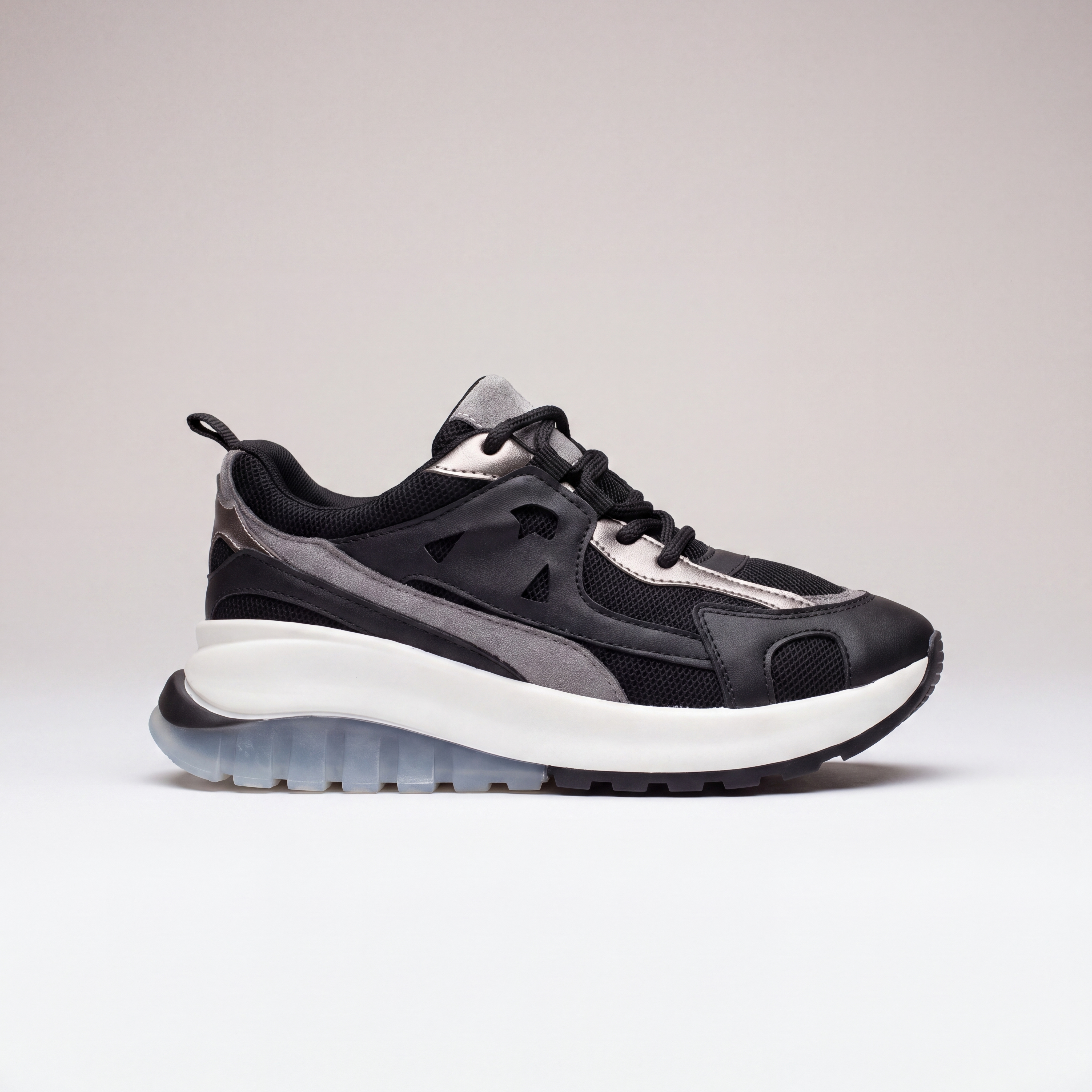 Black Shopify LAYER sneakers with sleek design, featuring black laces and a modern silhouette, on a plain background.