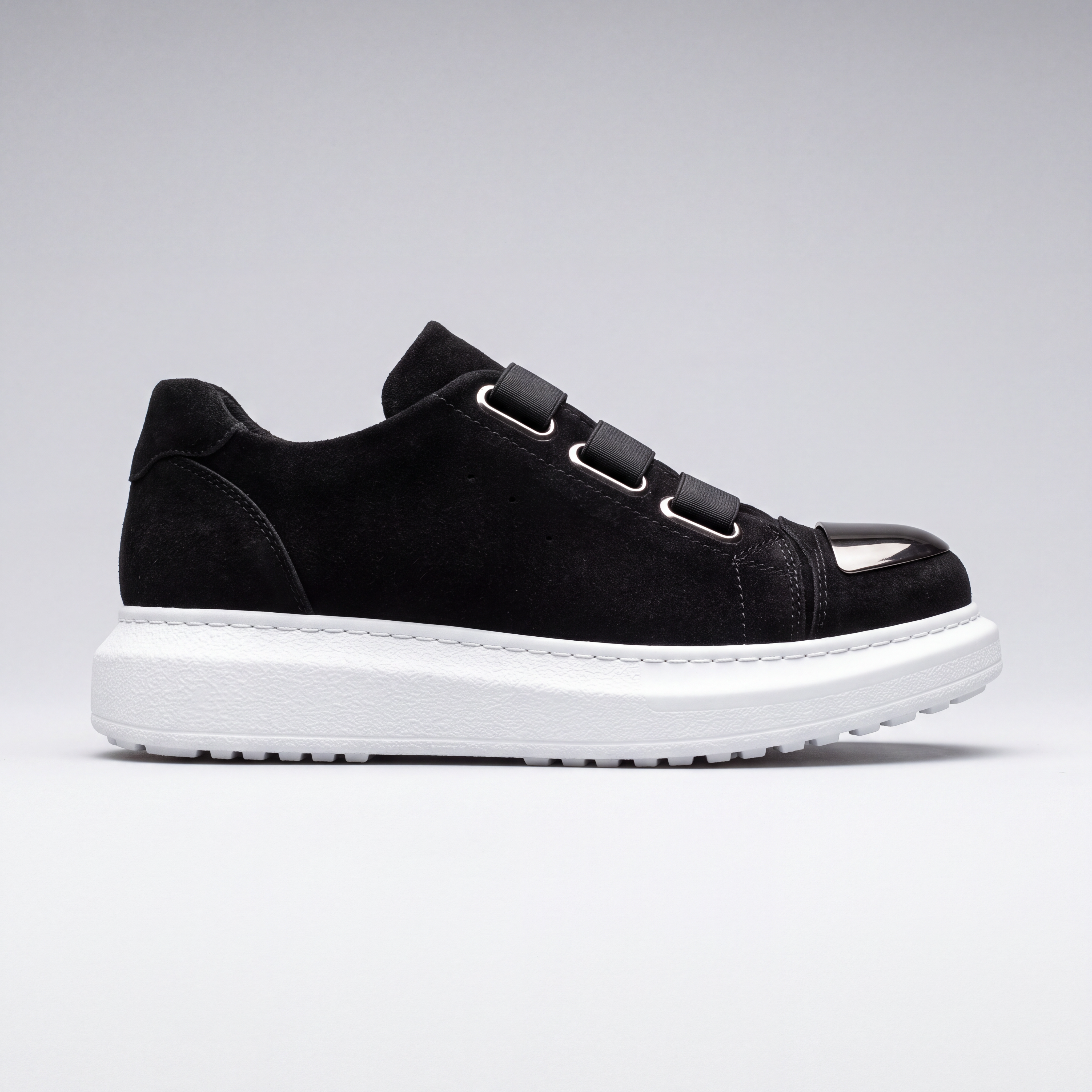 Shopify MIRROR Suede sneakers featuring a sleek design with suede material and stylish laces, displayed on a plain background.