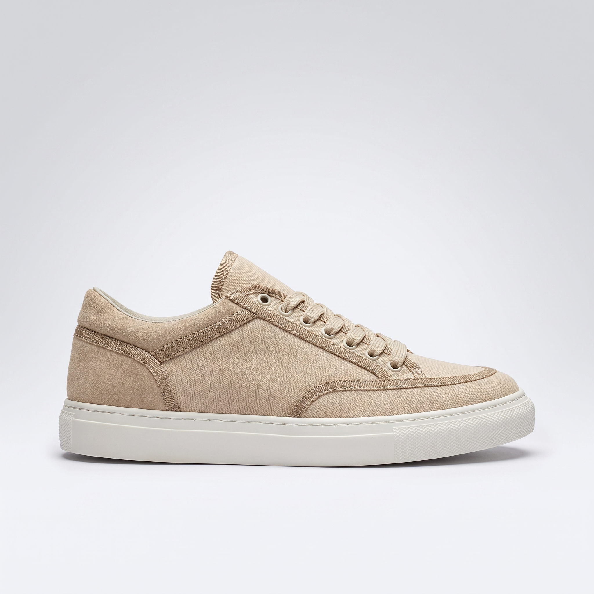 Shopify VAN beige sneakers with white soles and laces, casual athletic design, shown from a side angle.