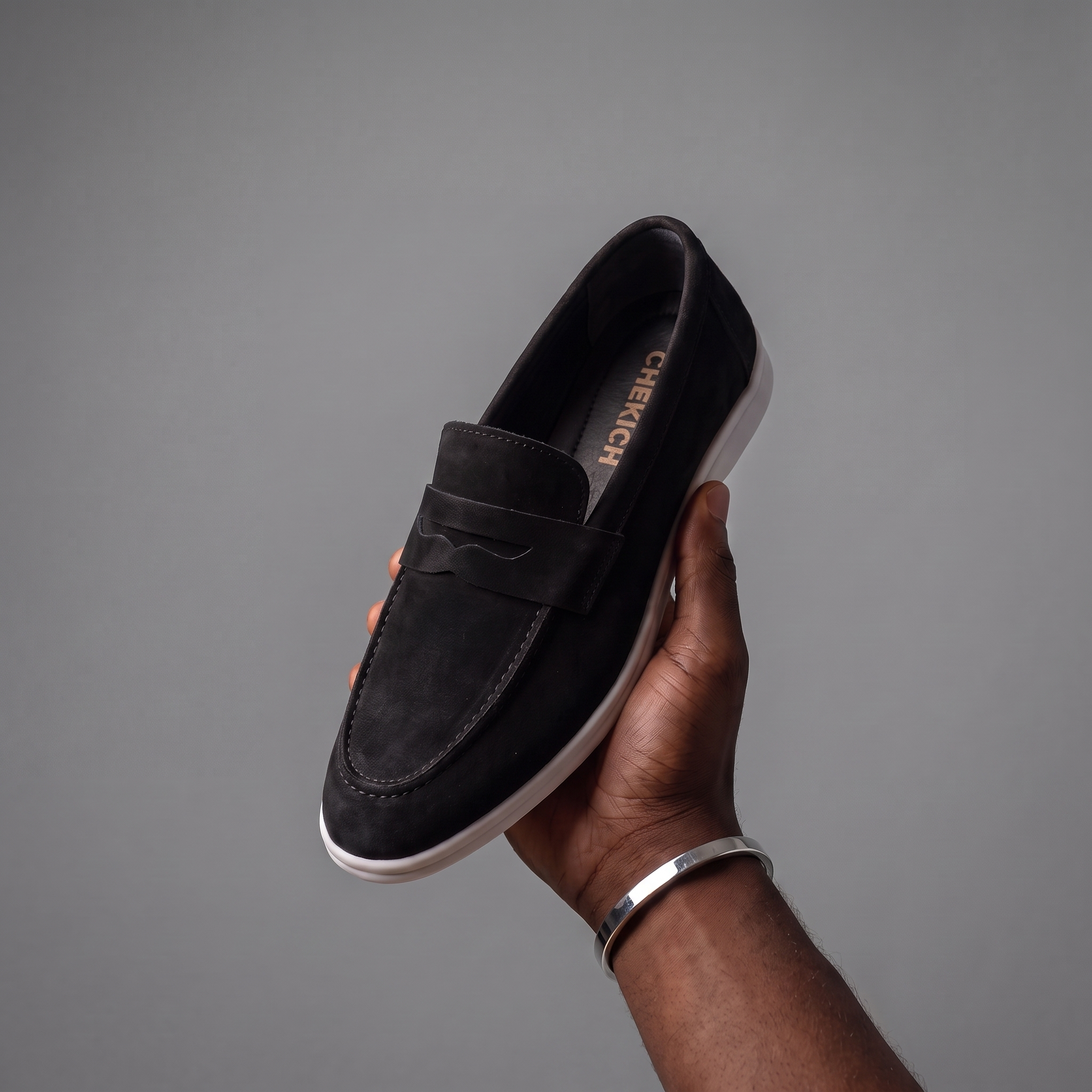 Black Clifton shoe by Chekich South Africa, showcasing its sleek design and black leather upper with detailed stitching.