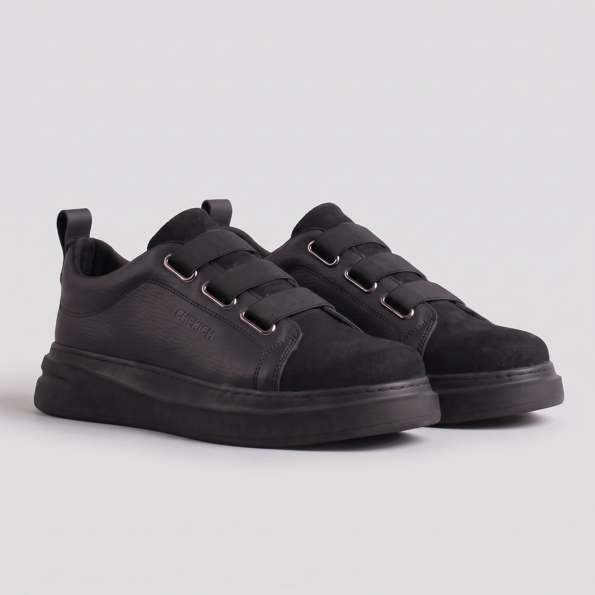 Chekich NONE V2 All Black sneakers pair, three-quarter view showing the three straps and tonal black sole