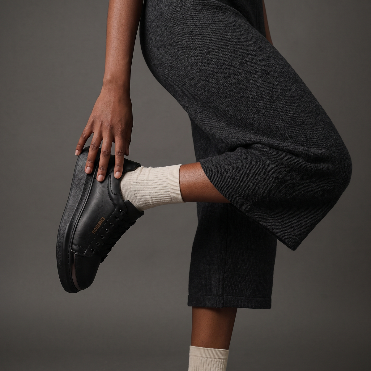 Chekich FANTASIA ST sneaker worn with white socks and wide black trousers