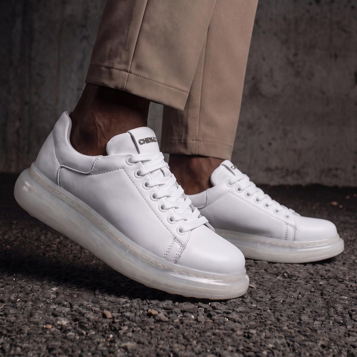 White FANTASIA X sneakers by Shopify with sleek design and comfortable fit, shown from a side angle.
