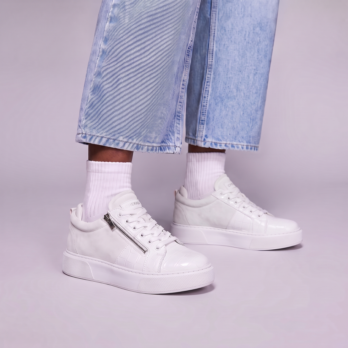 Chekich PHANTOM White sneakers worn with light denim, close-up of the zip and croc panel