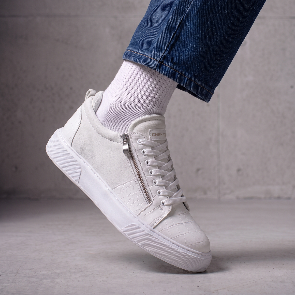 Chekich PHANTOM White sneaker worn with white socks, close-up showing the side zipper