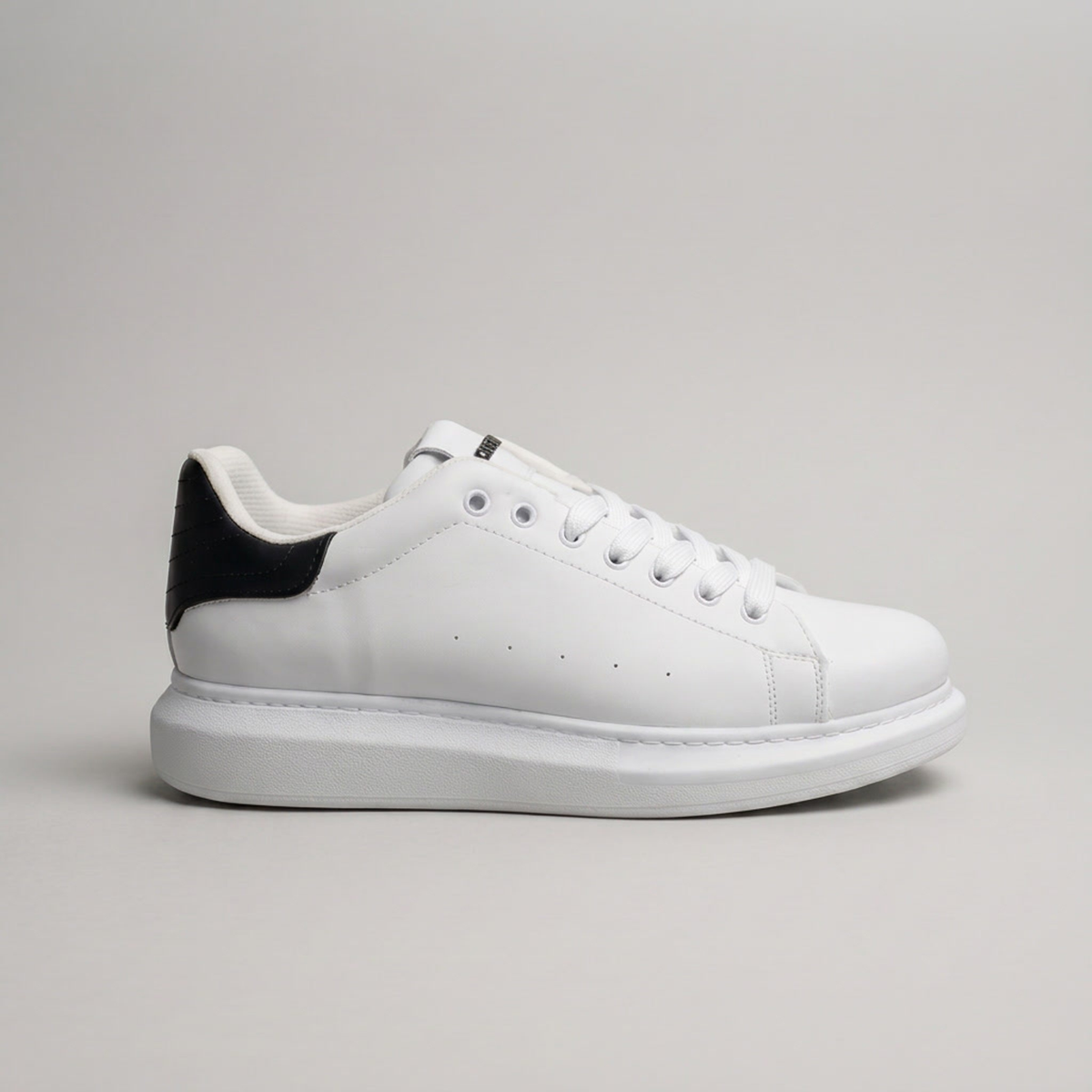 Black ORIGIN sneakers by Shopify with sleek design, featuring black laces and modern athletic style.