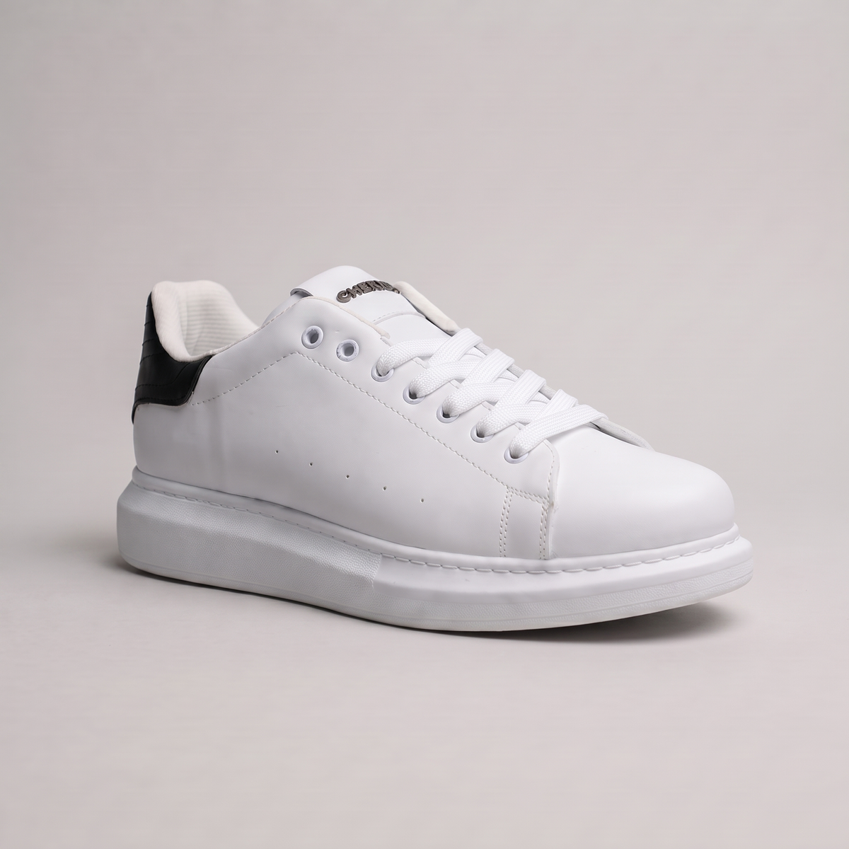 Black Shopify ORIGIN sneakers with sleek design and white sole, displayed on a white background.