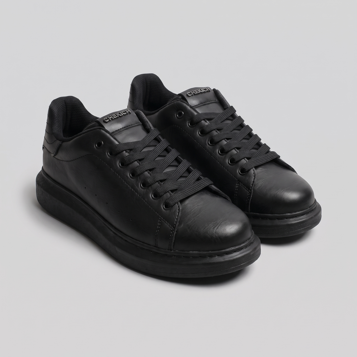 Black ORIGIN sneakers by Shopify featuring sleek design and comfortable fit, shown from a side view.