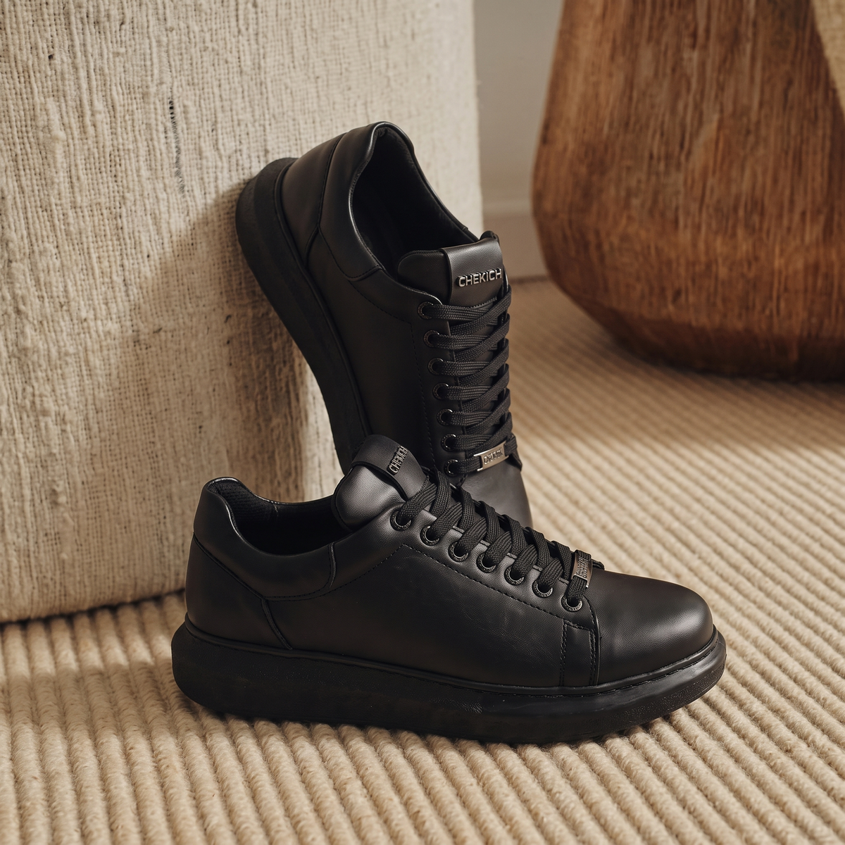 All black FANTASIA PLAIN sneakers by Shopify, featuring sleek design and classic lace-up style, shown on a plain background.