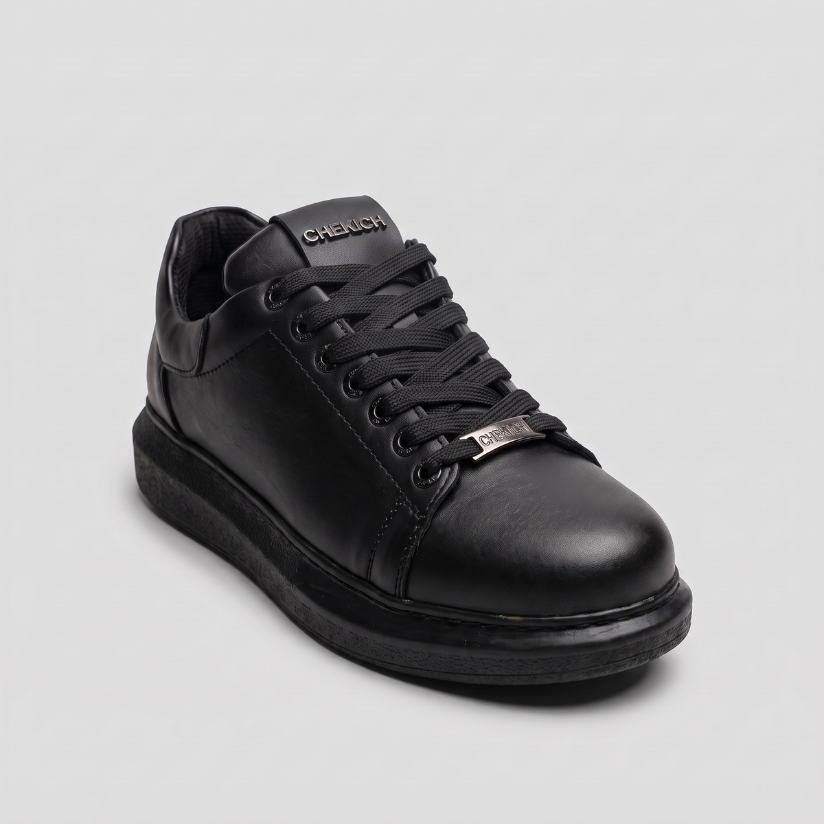 Chekich FANTASIA PLAIN All Black sneaker, side angle showing the metal lace tag