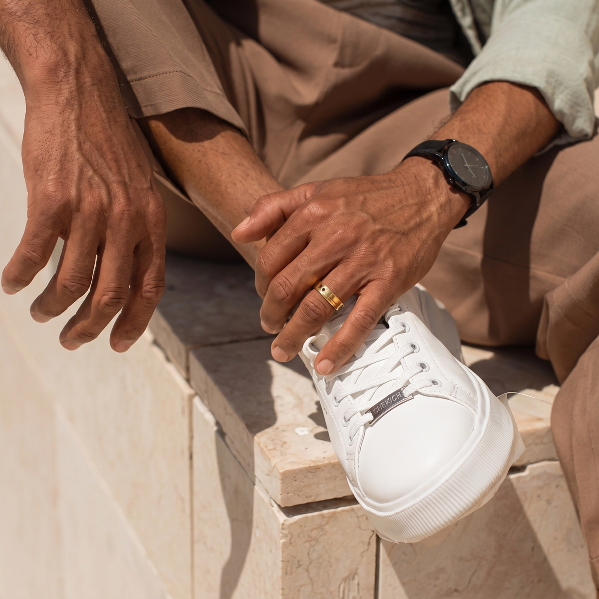 White fantasy plain sneakers by Shopify featuring a sleek design and comfortable fit, shown from a front angle.