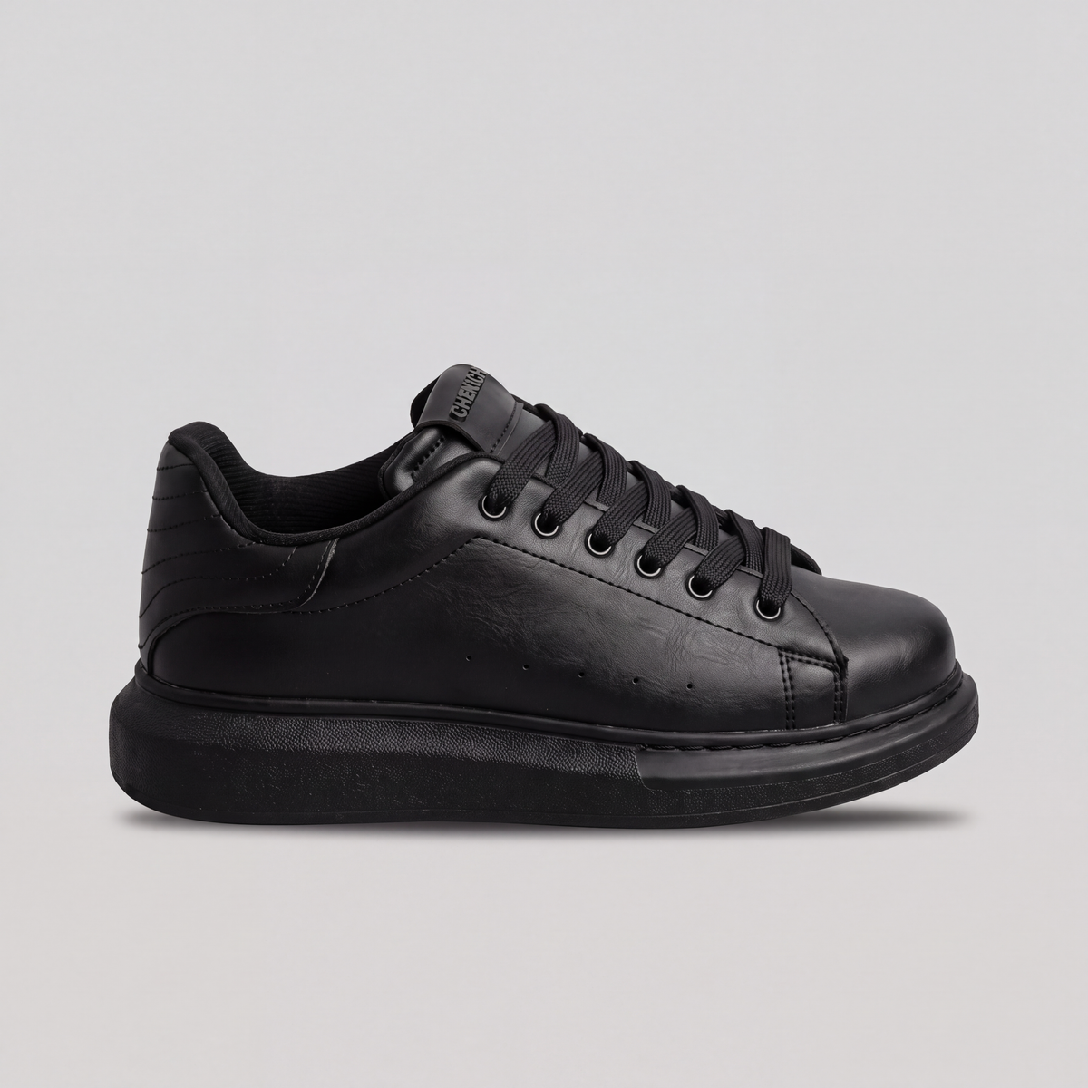 Black ORIGIN Sneakers by Shopify featuring a sleek design and comfortable fit, shown from a side angle.