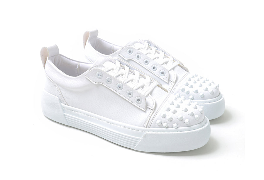 White Shopify Thorn sneakers with clean design and white laces, showcased from a front angle.